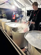 Chef Cooking in Large Steaming Pots Outdoors