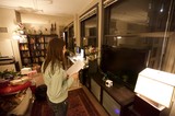 Woman Reading in a Cozy Book-Filled Apartment