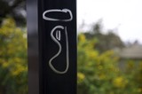 Engraved Metallic Post Against Blurred Natural Background