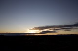 Dramatic Desert Sunset Over Distant Mountain Range