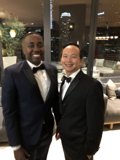 Two Men in Tuxedos Strike a Pose