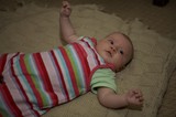 Curious Infant Awake on Knitted Blanket