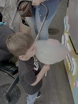 Child Enjoys Cotton Candy at Fair