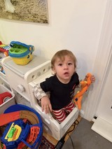 Toddler Playing with Toys in Learning Tower