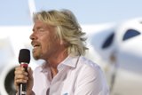 Richard Branson Takes the Stage with Microphone
