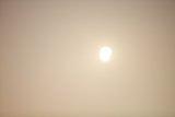 Sun's Illumination Over a Foggy Landscape