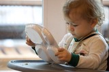 Toddler Exploring Mealtime Independence with Divided Plate