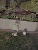 Motion Blur Child Playing on Sidewalk