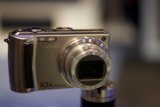 Shiny Silver Digital Camera on Stand