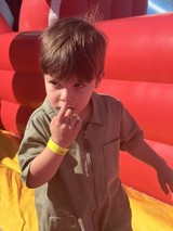 Young Boy Making Shh Gesture at Indoor Play Center