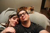 Couple and Their Calico Cat on the Couch