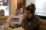 Cell Phone Conversation at a Cozy Cafe