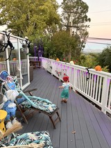 Toddler Exploring Misty Deck on Autumn Morning