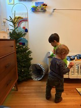 Two Young Children Exploring Their Christmas-Decorated Bedroom