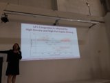 Woman delivering a presentation in front of a projection screen