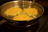 Trio of Eggs Sizzling on the Stove