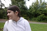 Young Woman with Daisy in Park Setting