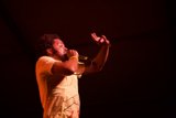 Yellow-Shirted Performer Takes the Stage with Microphone