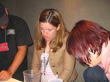Pink Shirted Woman Sips at Pub Table