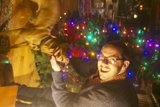 Man and Dog under Holiday Lights