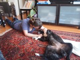 Woman Shares Tender Moment with Dog on Rug