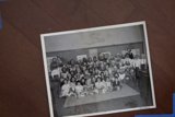 A Crowd of People Sitting on the Hardwood Floor
