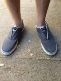 Grey Sneakers on a Sunny Sidewalk