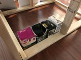 Wooden Shelf with Boxes and a Book