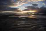 Fiery Sunset Reflections on Low Tide Sea