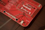 Red Circuit Board with a Ninja Badge Sticker