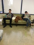 Two Men and a Dog Enjoy a Cozy Afternoon
