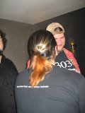 Black-Shirted Man with Ponytail and Baseball Cap