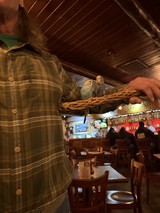 Pet Birds on Perch in Rustic Restaurant