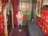 Woman Posing in Eclectic Red-Walled Venue Hallway