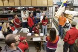 Group of People Gathered Around Plywood Table
