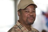Man in Plaid Shirt and Baseball Cap