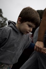 Young Boy in Thoughtful Moment at Indoor Setting