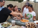 Man Enjoying a Slice of Pizza with Friends in a Restaurant
