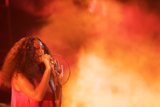 Solange Portrait Expressive Hand Near Mic Heavy Orange Smoke
