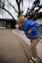 Young Boy in Blue Hoodie Playing Outdoors