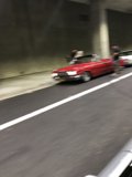 Red Sports Car Cruising Through the Tunnel