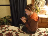 Young Woman Texting on Phone in Cozy Bedroom