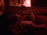 Two Men Reading a Mysterious Note in a Dark Room