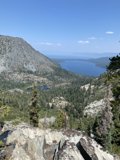 Serene View of Lake and Mountains from Rocky Hillside