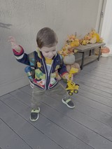 Toddler Playing with Yellow Toy Truck Indoors
