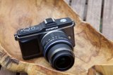 Olympus OM-D EM-5 Camera on Plywood Surface