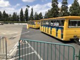 Bright Yellow Bus Parked Under a Blue Sky