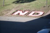 Red and White Sign on Grass Path