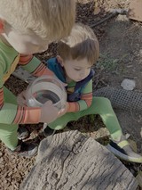 Children Exploring Nature with Magnifying Glass