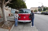 Friends Posing with Classic Red Volkswagen Bus